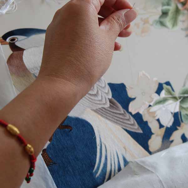 Chinese Embroidery Artist at SES Embroidering a Silk Embroidery of Bird and Cherry Blossoms Based on a Traditional Chinese Painting
