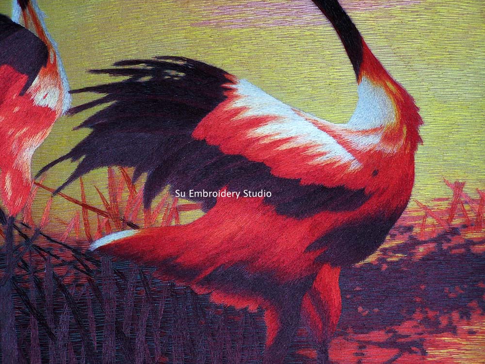 closeup of chinese silk embroidery dancing cranes