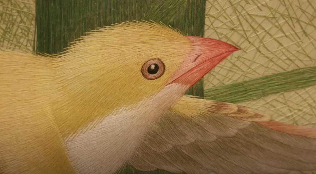 close-up of a silk hand embroidered bird